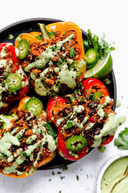 Vegan Stuffed Peppers With Cilantro Lime Crema Plays Well With Butter Recipe Stuffed Peppers Vegan Stuffed Peppers Vegetarian Stuffed Peppers