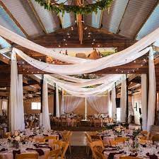 Go For Grandeur By Draping White Chiffon Around The Venue The Long Flowing Material Will Show Off Th Barn Wedding Decorations Wedding Ceiling Barn Wedding