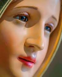 What are the middle beads between the decades of a rosary called?