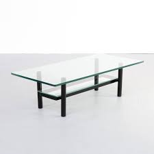 Pair glass table tops with distressed wood for a shabby chic appearance. 80s Solid Metal Glass Coffee Table 145031