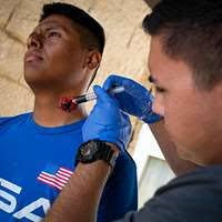 Hospital Corpsman 1st Class Stephanie Acevedo, from Arlington, Ill.,  listens to the heartbeat of Hospital Corpsman Hospitalman Apprentice  Chester Williams,