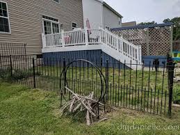 Pressure mounted metal pet gate for deck stairs. How To Install An Easy No Dig Fenced Dog Run In One Day Diy Danielle