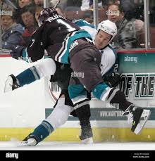 Anaheim Mighty Ducks' Jonathan Hedstrom of Sweden, foreground, checks San  Jose Sharks' Scott Hannan into the boards in the third period of a NHL  hockey game in Anaheim, Calif.