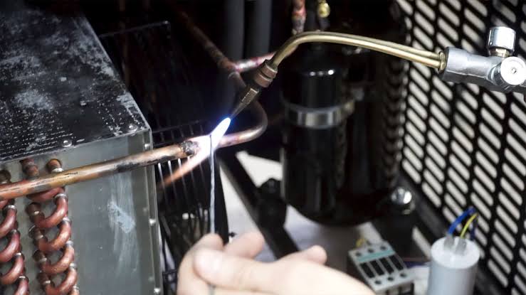Brazing a copper joint using an oxy-acetylene torch and silver alloy rod, AI generated
