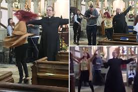 Church of England priest Reverend Richard Coles ​prances down the aisle