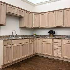 Rich hardwood floors and crisp white trim add contrast, making the cabinetry paint color read as a soft taupe. Oak Unfinished Kitchen Cabinet Home Outlet