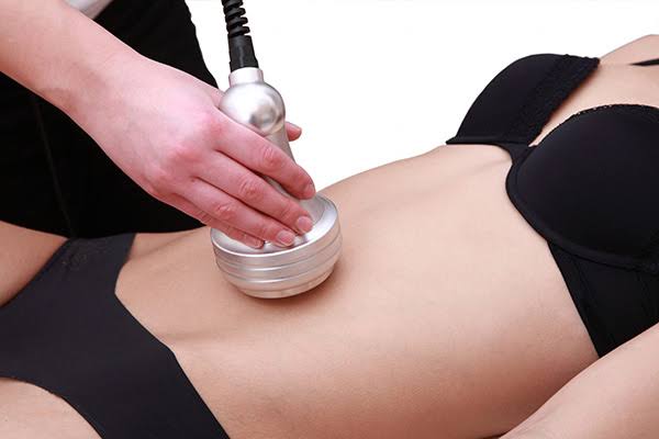 Woman during a treatment with a slimming machine