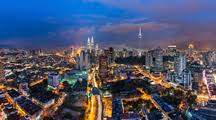 With reference to malicious allegations contained in a post in an unverified online site. Cityscape Of Kuala Lumpur Malaysia At Dusk With Illuminated Petronas Towers And Communication Tower In The Distance Stockphoto