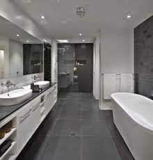 Gray bathroom ideas using gray tiles are perfect for designing a neutral bathroom space that men and women can both enjoy equally. Bathroom Floor To Roof Charcoal Tiles With A Black Counter And Grey Cabinets Everything Else White Bathroom Tiles Gray Tile Bathroom Floor Grey Bathroom Floor