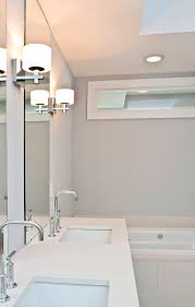 Transom Window Above Bathtub Area To Allow Natural Light Into A Bathroom Located In The Interior Portio Modern Bathroom Design Bathroom Windows Bathroom Design