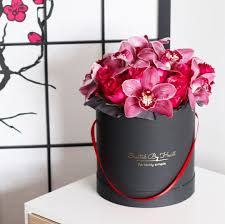 A small, beautiful bouquet of pink roses is decorated with greenery. Mix Of Hot Pink Orchids And Roses In A Signature Black Gold Box Flowers Gifts And Home Decor In Nyc And Brooklyn