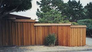 Board and batten detailing a charming aesthetic on the walls. Capped Wood Board And Batten Fence Wood Fence Types Of Fences Fence