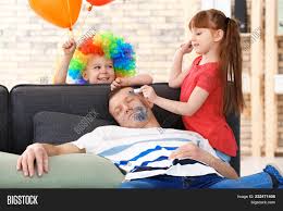 That the kids were sat patiently by their dad, quietly drawing him. Little Children Painting Their Father S Face While He Sleeping April Fool S Day Prank Image Stock Photo 232471408