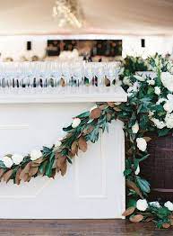 A Lush Magnolia Leaf And White Bloom Garland On The Bar For A Chic Look Magnolias Wedding Bouquet Magnolia Wedding Magnolia Leaves Wedding