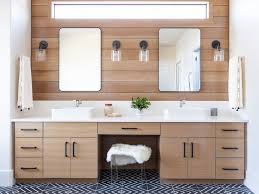 A double walnut vanity is topped with a clean white countertop in this chic bathroom. 23 Gorgeous Bathroom Cabinet Ideas For Any Style