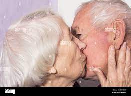 The senior woman kissing old man Stock Photo - Alamy
