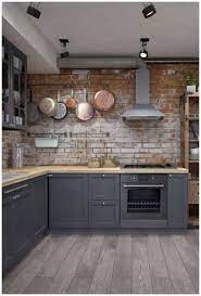 This kitchen simple but elegant kitchen features a handful of industrial finishes, from the exposed pipework and chrome extractor fan, to the exposed brick wall and pendant lights. Industrial Kitchen Ideas Home Decoomo