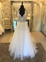 Alluring contrasts are glimpsed in pairings like twinkle and matte, giving each dress an unmistakable charisma that enhances the bride's own captivating charm. Hayley Paige Dakota Wedding Dresses Kent