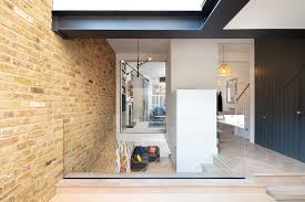 'if you'd like to create a slightly edgier style then try mixing a classic marble with wood effect tiles for a more contemporary feature floor area. Chivalry Road Sketch Architects Archdaily
