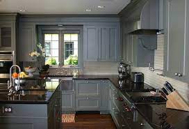 A variegated stone backsplash combines the tan and grey to create a striking visual interest along the walls. Kitchens Blue Gray Shaker Kitchen Cabinets Pot Filler Blue Gray Kitchen Islan Grey Painted Kitchen Diy Kitchen Cabinets Makeover Grey Kitchen Designs