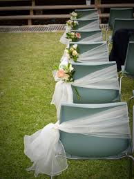 Even Plain Plastic Chairs Can Be Turned Into A Lovely Wedding Piece Check Out Navarragardens Com For Wedding Chair Decorations Wedding Chairs Plastic Wedding