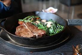 How do you fry and bake a steak? Hd Wallpaper Photo Of Black Frying Pan With Brown Meat Steak T Bone Steak Wallpaper Flare