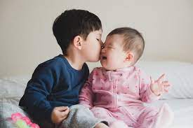Big Brother Giving Baby Sister A Kiss By Lauren Lee