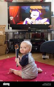 Baby With Remote Control Tv Remote Tv Watch Child Changing Baby Movie Calm Boy Power Music Calmness Television Sit Stock Photo Alamy