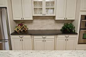 White lanterns light a steel gray kitchen island accented with a black leathered granite countertop holding a stainless steel sink beneath a stainless steel industrial faucet. Leathered Granite Houzz