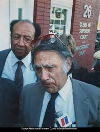 Wayne Williams defense attorney William Kuntsler speaking to the press with  William's father Homer about a potential new trial, 1985