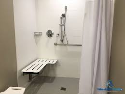 The customer uses a wheelchair and wants a curbless shower in a bathroom with a tiled floor. The Good Bad Of Ada Accessible Hotel Bathrooms Wheelchair Travel