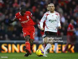Arvelo Arbeloa of Liverpool shields the ball away from Tuncay Sanli... News  Photo