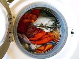 Unfortunately, some types of fabric—notably cotton—aren't colorfast, so their dye molecules wind up in the wash water and settle on other fabrics, most noticeably on white and other light ones. Washing Machine With Colored Clothes Stock Image Colourbox