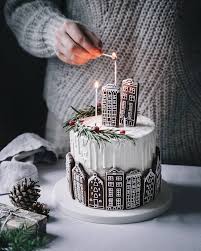 This special cake looks so elegant and beautiful. Gingerbread Houses In The City Tall Elegant Christmas Cake Shell Decorations Christmas Cake Christmas Desserts Cake Decorating