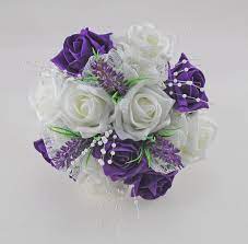 Silk casablanca, silk peony, foam roses, stephanotis, alliums, calla lily this beautiful brides shower bouquet is made using a mixture of artificial wedding flowers, dark grey and black foam roses, ivory casablanca, purple peonies, stephanotis, purple alliums and ivory calla lilies. Bridesmaids Purple Ivory Rose Wedding Bouquet With Lavender Lace Budget Wedding Flowers