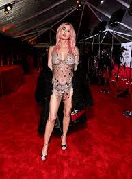 Megan Fox goes naked in just chain metal and a black fur coat at Grammys  party as fans slam disturbing detail | The US Sun