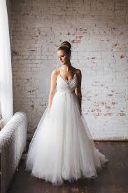 A Stylish Snowy Affair Alyssa Dan At Atb Financial Arts Barns Bridal Looks Wedding Dresses Designer Wedding Dresses