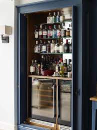 A refrigerator (colloquially fridge) is a home appliance consisting of a thermally insulated compartment and a heat pump (mechanical, electronic or chemical) that transfers heat from its inside to its external environment so that its inside is cooled to a temperature below the room temperature. Modern Bar Cabinets For Home Novocom Top