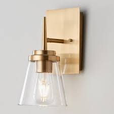 Wall lights are particularly useful in the bathroom, where they can provide necessary lighting around the vanity mirror. Tapered Spike Bath Sconce Sconces Gold Bathroom Fixtures Contemporary Wall Sconces