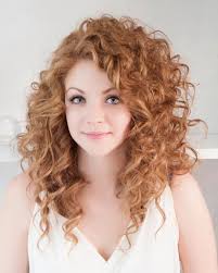 Strawberry Blonde Woman With Medium Long Hair Curly With Side Part Wearing A Whi Long Curly Haircuts Long Layered Curly Haircuts Curly Hair Styles Naturally
