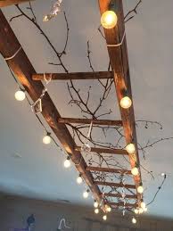 Use Patio Lights And A Old Ladder To Make A Statement Ceiling Light Fixture Diy Lights Vintage Chandelier Home Diy