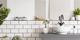 Bathroom with painted white floor, pendant lamp, and pink accents. Timeless Bathroom Decor Trends That Will Never Go Out Of Style Real Simple