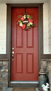 Cream And Chocolate Brown House With Burnt Orange Door And Coral Colored Spring Wreath Exterior Door Colors Painted Front Doors Best Front Door Colors