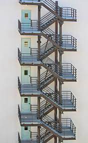 The clear distance between the slope line adjoining the tread to the floor of the above floor is known as headroom. Hd Wallpaper Photography Of Building Fire Exit Stairs Fire Escape Emergency Exits Wallpaper Flare