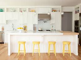 To give a strong character to the white kitchen, installing patterned tiles like these work well. 15 Painting With Yellow Moody Mar14 Four Bar Stools In White Kitchen House Home