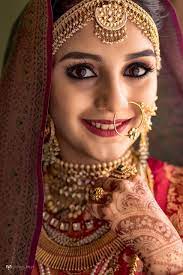 Traditional Indian Bride In Red And Gold Indian Bride Makeup Indian Bride Poses Indian Bridal Makeup
