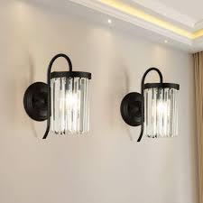 Gray and brown dining room featuring neutral decor and furnishings boasting a white oval sunburst mirror on a board and batten cream wall flanked by white lamp sconces. Maxax Crystal Wall Sconces Set Of 2 Wall Lamp With Clear Glass Prisms For Dining Room Bedroom Bedside Living Room Hallway Black Finish Buy Online In Cayman Islands At Cayman Desertcart Com Productid 152979060