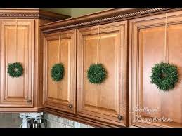 One Of The Most Simple And Frugal Ways To Decorate Your Kitchen For Christmas Is By Making These Easy Diy Min Kitchen Cabinets Decor Cabinet Decor Mini Wreaths