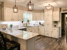 Next, immediately paint the remaining flat areas of the door using a mini roller. Kitchen Cabinets In Alabaster Painted By Kayla Payne