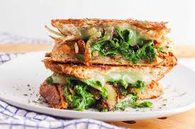 Place 1 slice of bread on the grill pan and top with a layer of tofu,. Cheesy Veggie Panini Recipe Kale Caramelized Onions